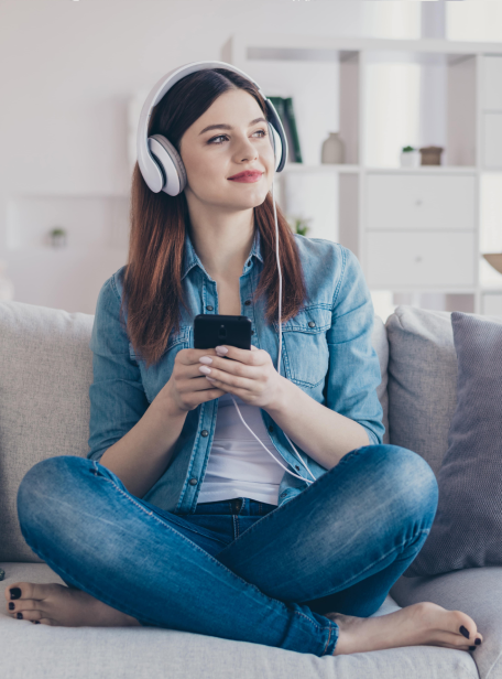 girl listening to phone on couch