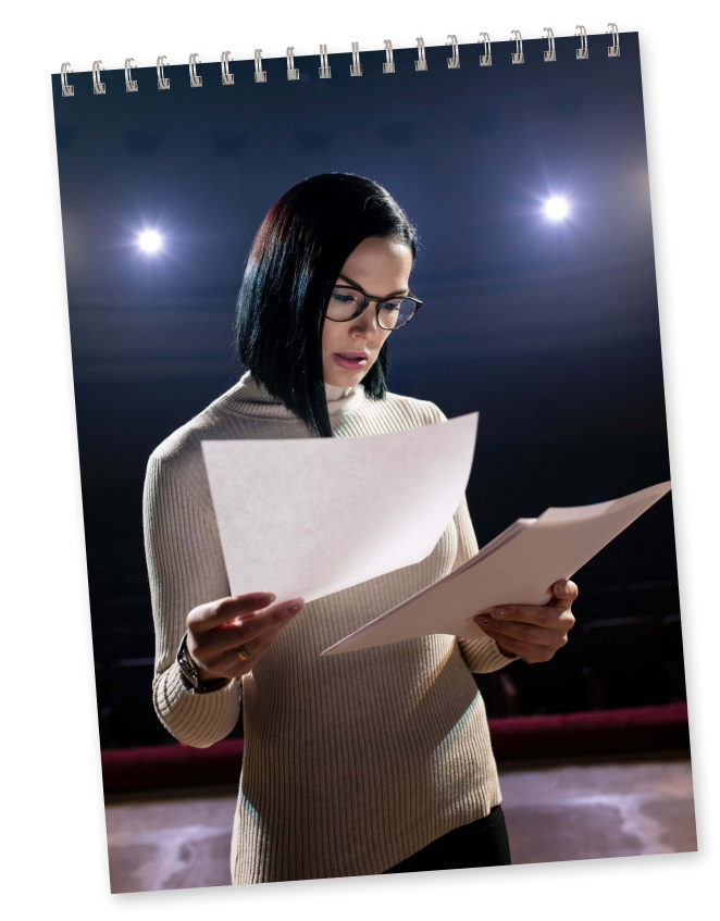 girl with glasses reading script