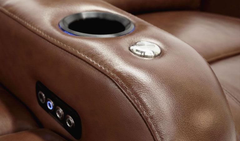 brown theater seating with cup holder